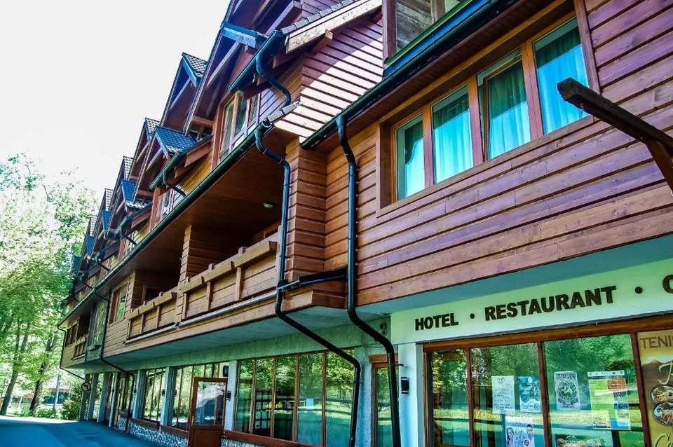 Entrance to Penzión SIMI — a timber building with balconies