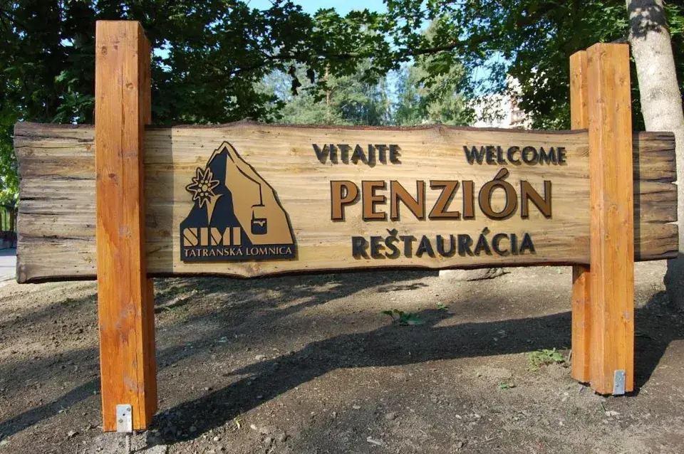 Vítejte — tabule před penzionem